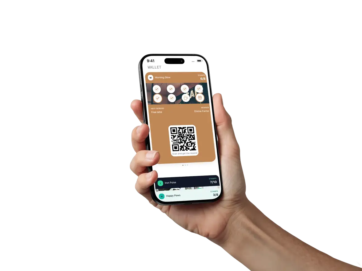 A hand holding a phone that shows a Loyanly loyalty card in Apple Wallet.