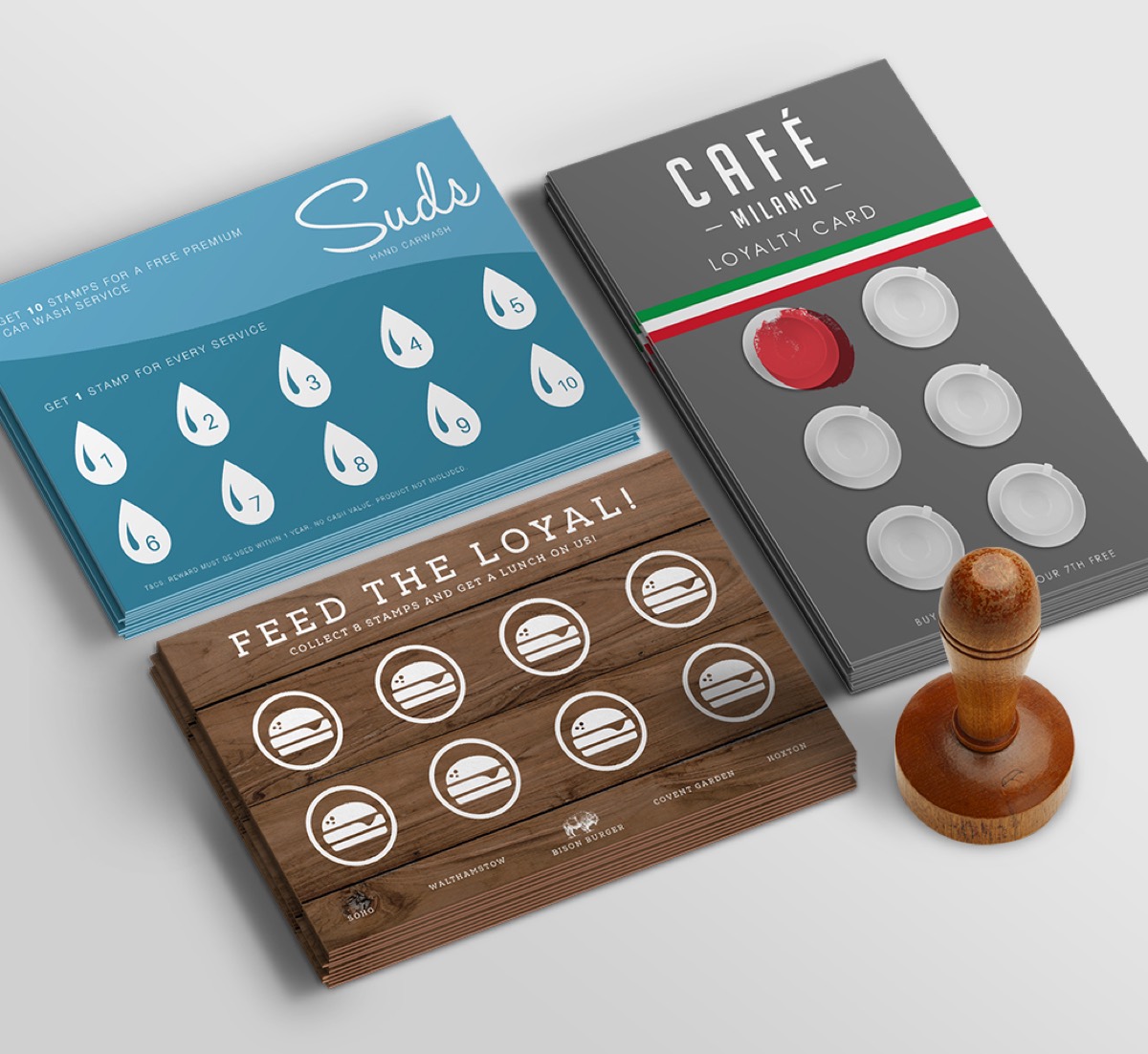 Three different loyalty card designs laid flat next to a stamp.